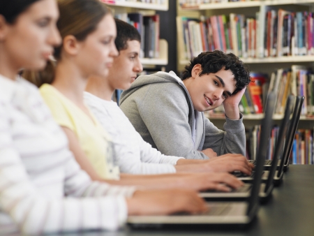 Students Using Laptops in Libraryの写真素材