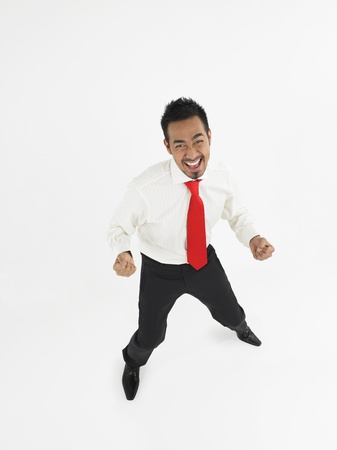 Man celebrating in studio full lengthの写真素材