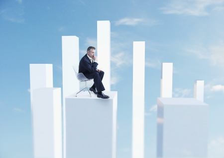 Businessman Sitting on Graphの写真素材