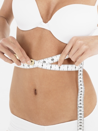Young Woman Measuring Waistの写真素材