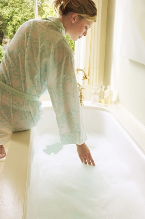 Woman Preparing Bubble Bathの写真素材