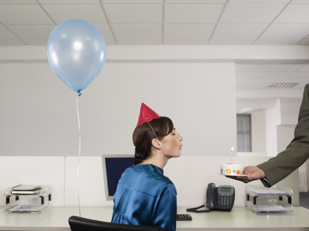 Woman Having Birthday at Workの写真素材