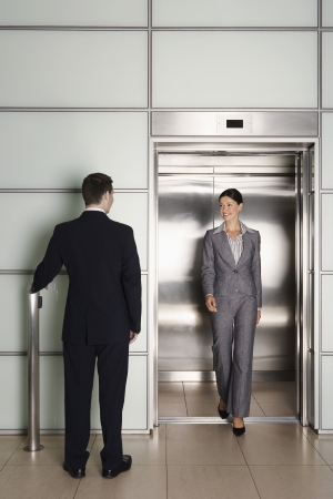 Businesspeople Using Office Elevatorの写真素材