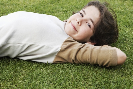 Little Boy Lying on the Grassの写真素材