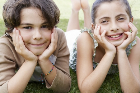Boy and Girl Lying on Lawnの写真素材