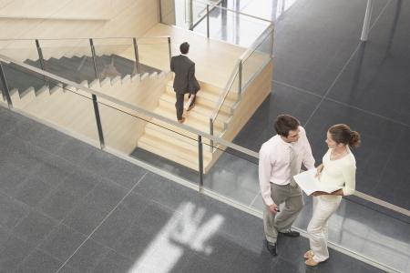 Businessman and Businesswoman on Office Balconyの写真素材