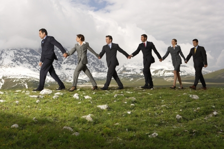 Business People Holding Hands and Walkingの写真素材
