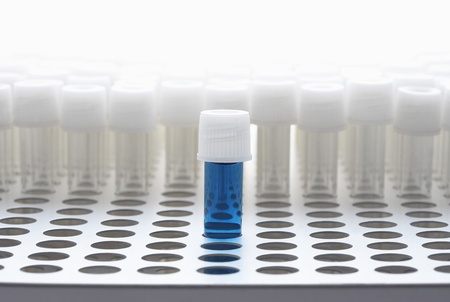 Blue test tube with empty test tubesの写真素材