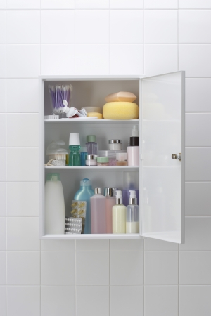 Various cosmetics and bath products in bathroom cabinetの写真素材