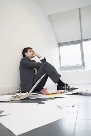 Businessman Sitting on Floor of Empty Officeの写真素材