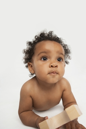 Baby Holding a Building Blockの写真素材