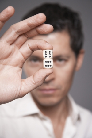 Man Holding Diceの写真素材