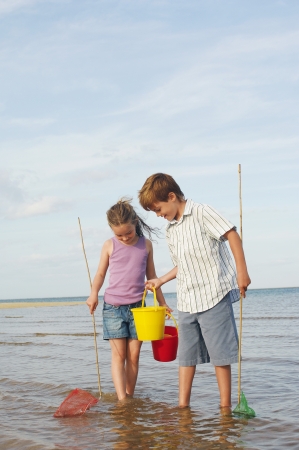 Brother and Sister Playing on Beachの写真素材