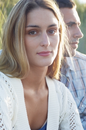 Young Woman Sitting by Boyfriendの写真素材