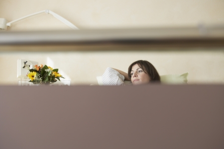 Patient Resting in Hospital Bedの写真素材