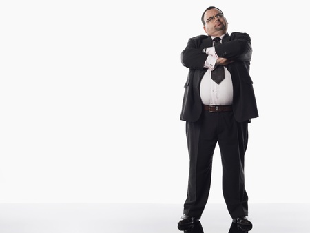 Overweight businessman with arms crossedの写真素材