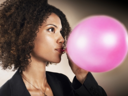 Businesswoman Blowing up Balloonの写真素材