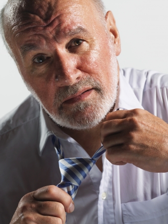 Hot businessman loosening tie close-upの写真素材