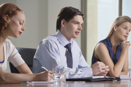 Three businesspeople sitting at business meetingの写真素材