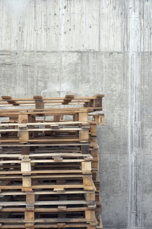 Stack of pallets against concrete wallの写真素材