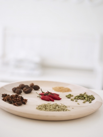 Variety of spices on wooden serving platterの写真素材