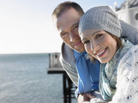 Couple standing on pier portraitの写真素材