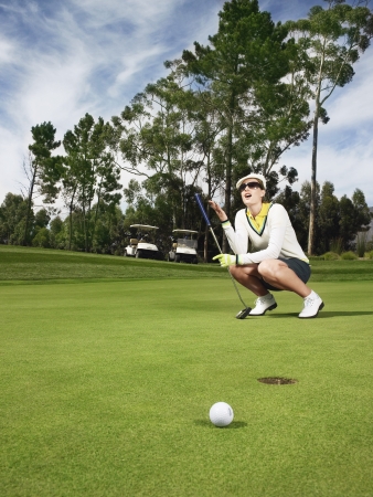 Golfer on putting greenの写真素材