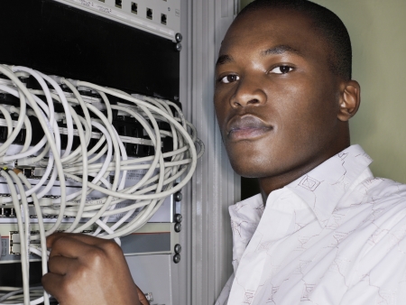 Man connecting network cables.