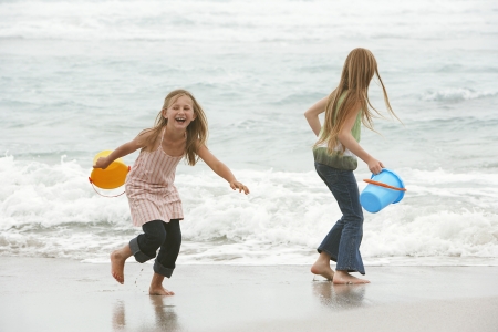 Two Girls Playing at the Oceanの写真素材