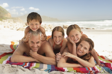 Family lying on beach.の写真素材