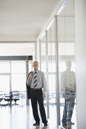 Businessman standing in Corridor portrait.の写真素材