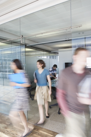 Office workers leaving conference room long exposureの写真素材