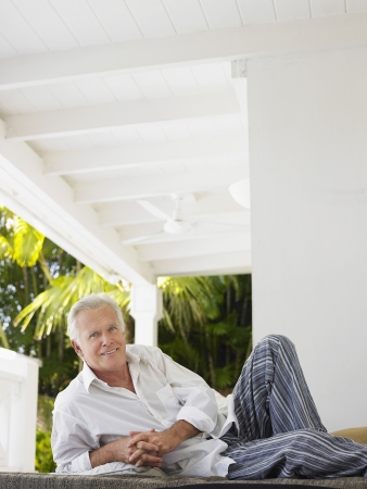 Man reclining on verandah portraitの写真素材