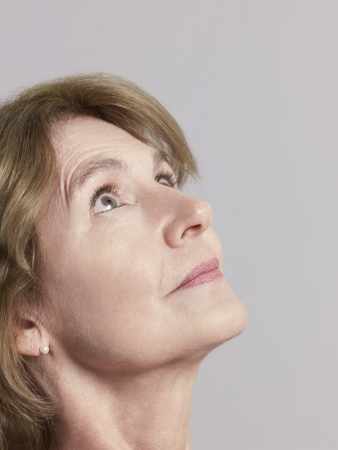 Middle-aged woman looking up close-upの写真素材