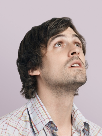 Mid adult man looking up close-upの写真素材