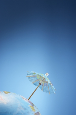 Drink umbrella on globe studio shotの写真素材