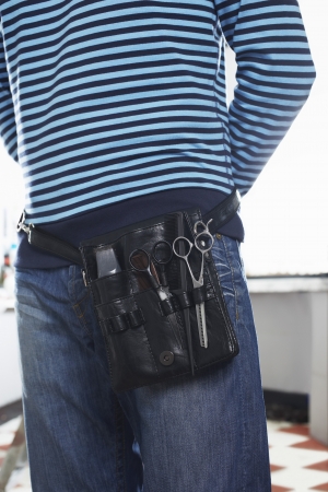 Barber with scissors in belt mid sectionの写真素材