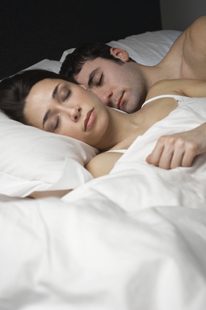 Couple sleeping in bedの写真素材