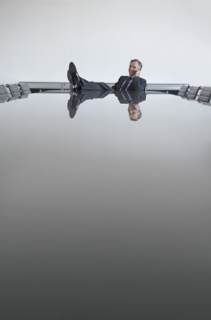 Business man with feet up on table in conference roomの写真素材
