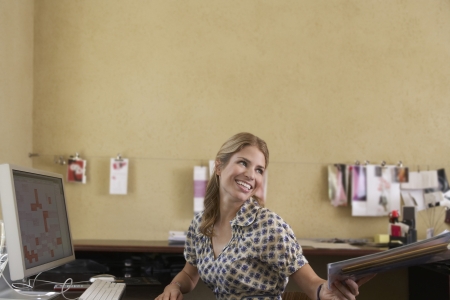 Woman handing off papers in office