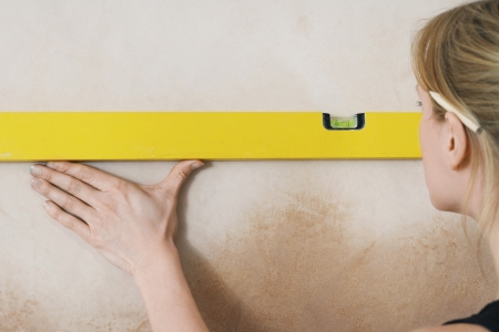 Woman using spirit level close-up