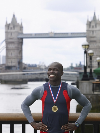 Man standing in front of Tower Bridge wearing medal England Londonの写真素材