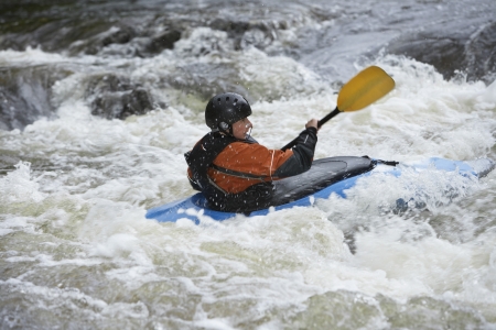 Man kayaking in riverの写真素材