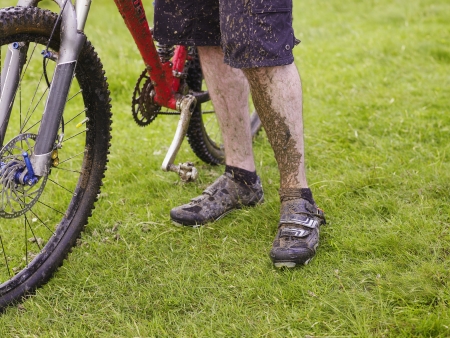 Muddy cyclist with bike outdoorsの写真素材