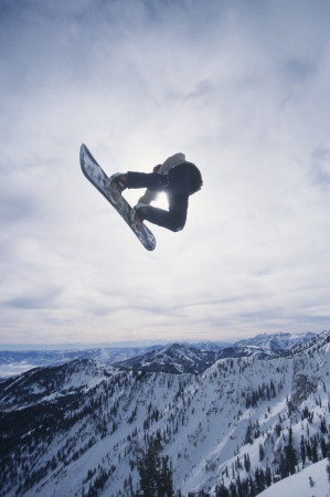 Person on snowboard jumpingの写真素材