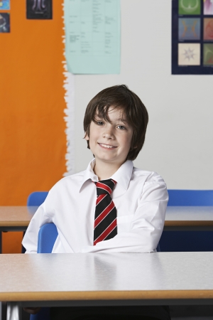 Boy (10-12) wearing shirt and tie in classroomの写真素材