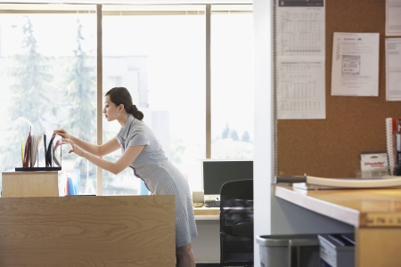 Woman checking files in officeの写真素材