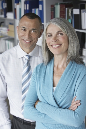 Business couple standing in office portrait elevated viewの写真素材