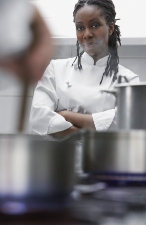 Female chef in kitchen portraitの写真素材