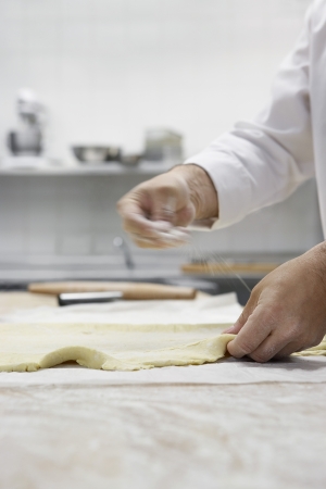 Chef preparing dough in kitchenの写真素材